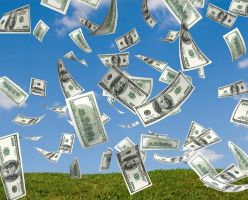 money falling in the sky and green grass background